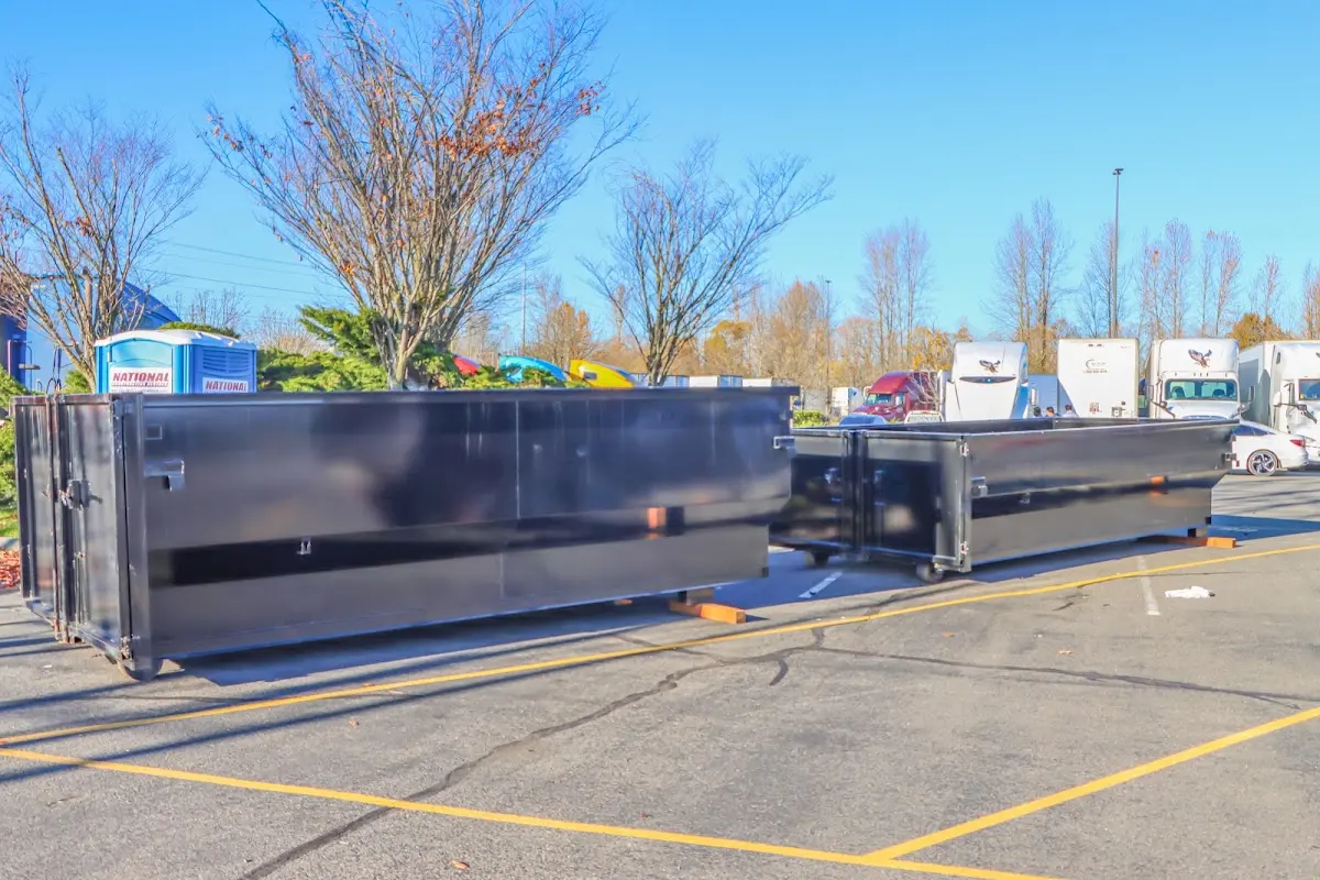 Professional dumpster rental service with roll-off container on residential driveway in Orange Cove